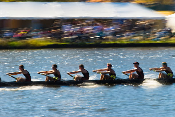 A team of rowers synchronizing their strokes during a race, symbolizing teamwork, coordination, and effort.